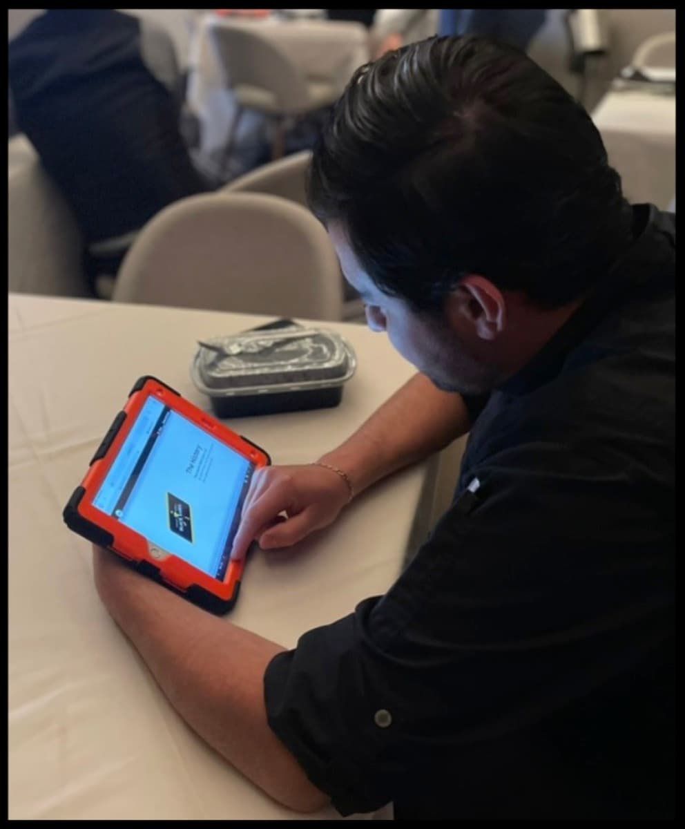 A staff member taking a flash quiz on a tablet before service