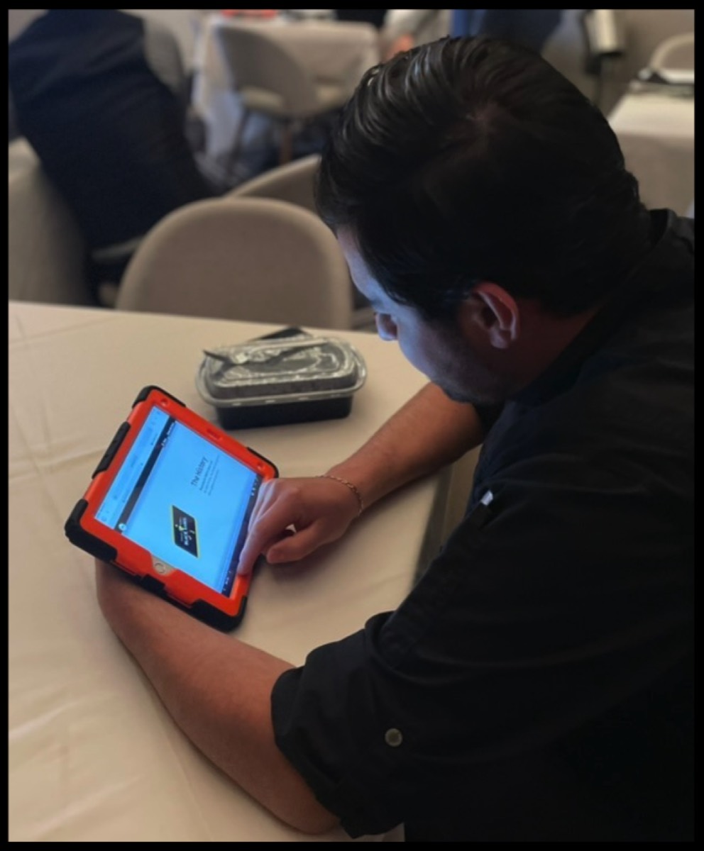 A staff member taking a flash quiz on a tablet before service